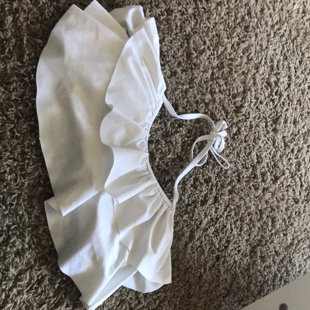 A white bathing suit top with a tie